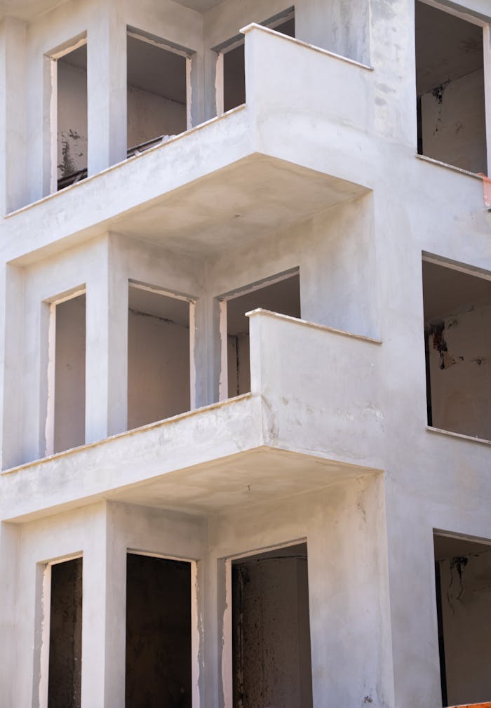 services-02 Closeup of an unfinished concrete building under construction in Antalya, Turkey, showcasing structural details.