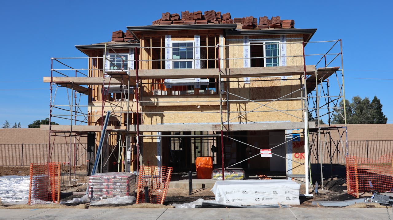 ours-journey Construction underway for a new home in Elk Grove, California. Scaffolding and materials onsite.