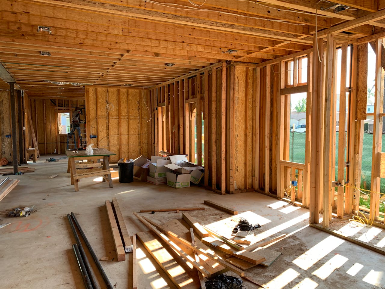 services-01 Sunlit interior with wood framing, showcasing home construction progress.